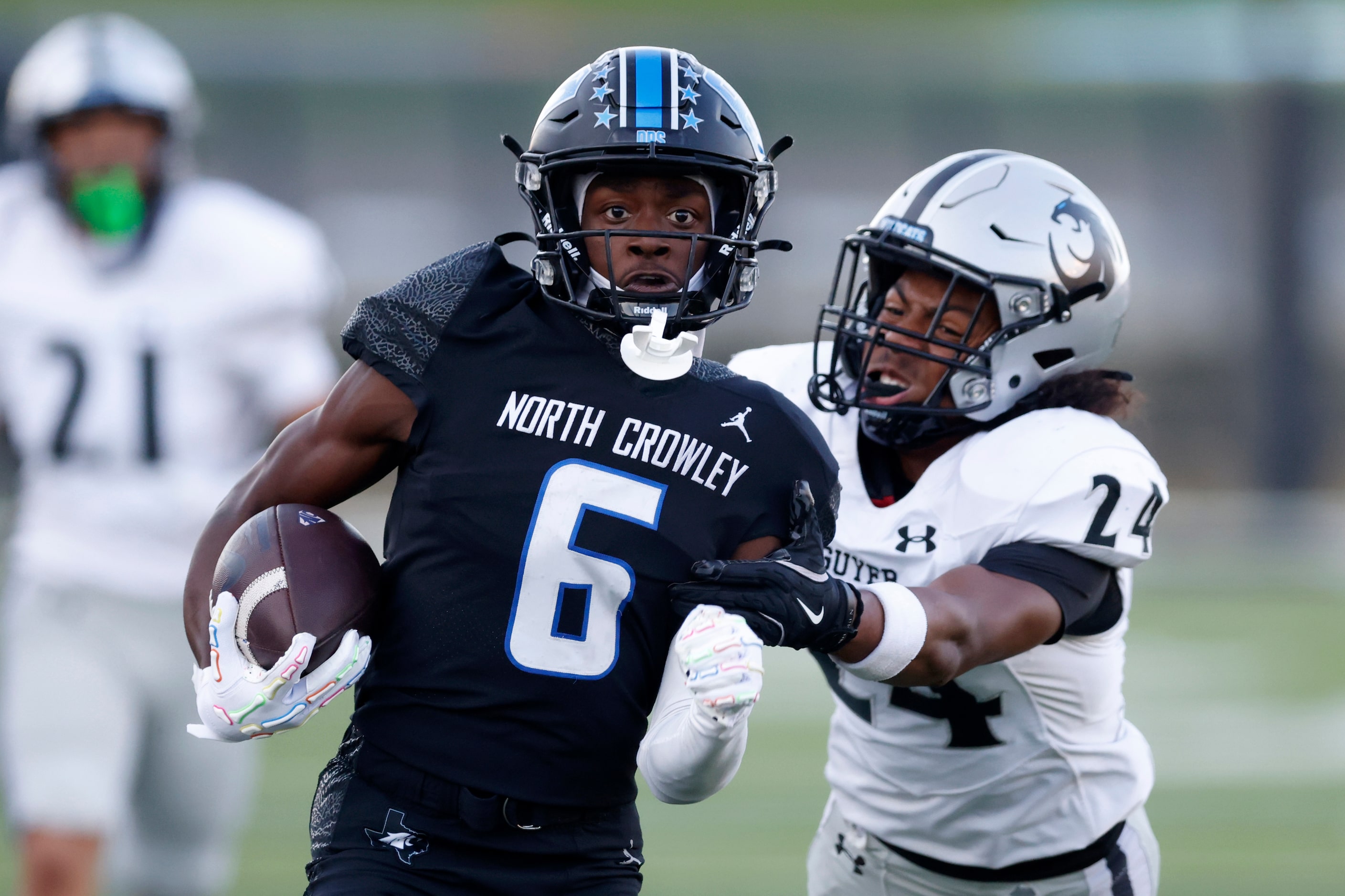 Denton Guyer defensive back Paxton Williams (24) tries to tackle North Crowley wide receiver...