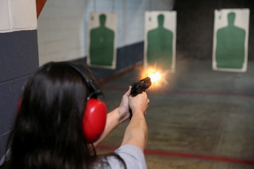 Angela Carter, of Santa Fe, Texas, shoots during a license to carry class hosted by Mark...