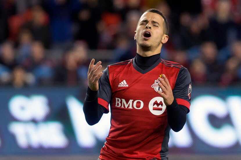 Toronto FC's Sebastian Giovinco reacts after missing a goal scoring opportunity during the...