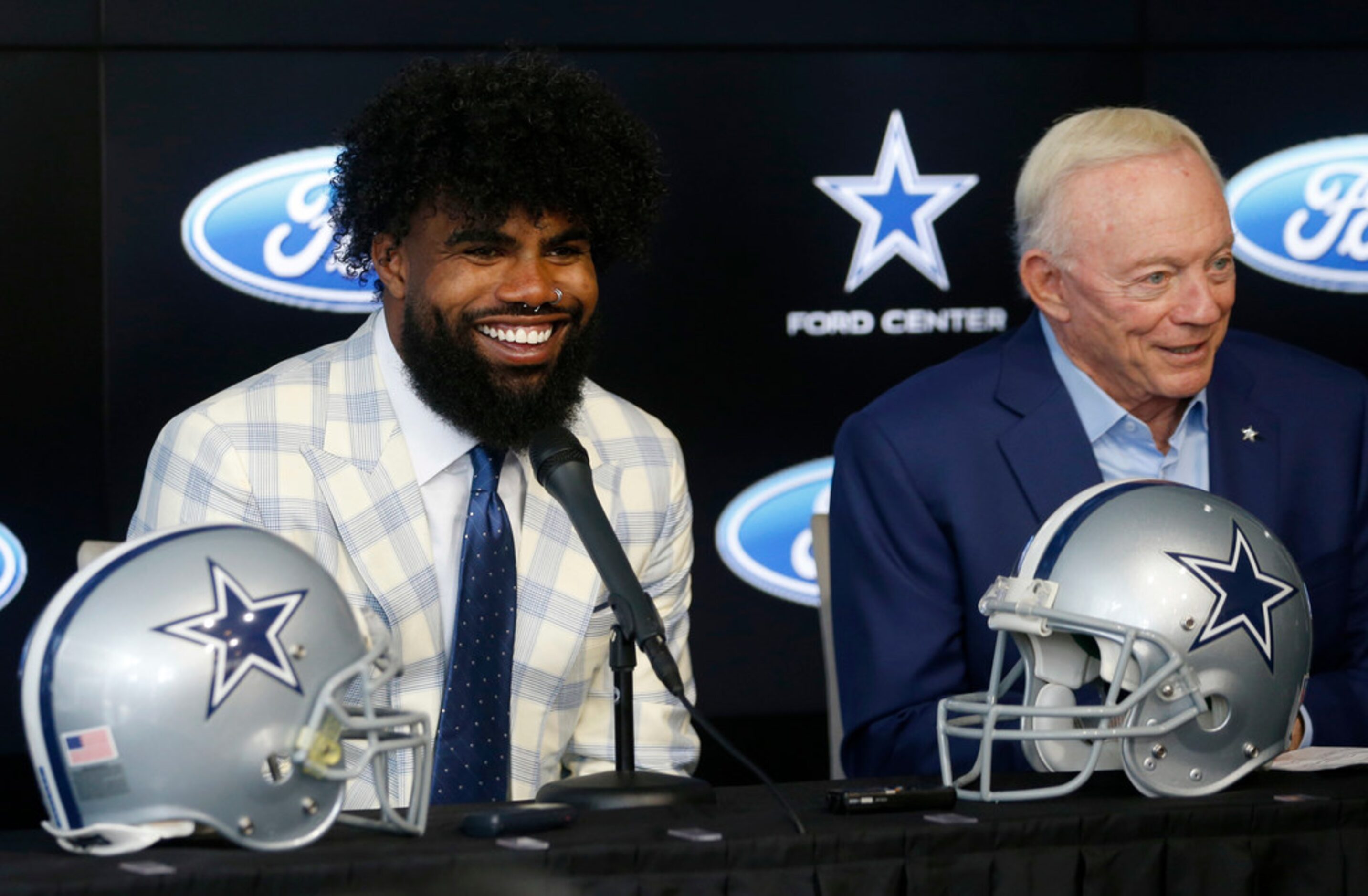 Dallas Cowboys running back Ezekiel Elliott (21) smiles as he sits next to Dallas Cowboys...