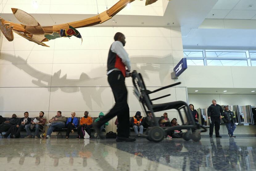 D/FW Airport employee Mohammed Sheikhaldeen pushes a cart in terminal D in Dallas/Fort Worth...