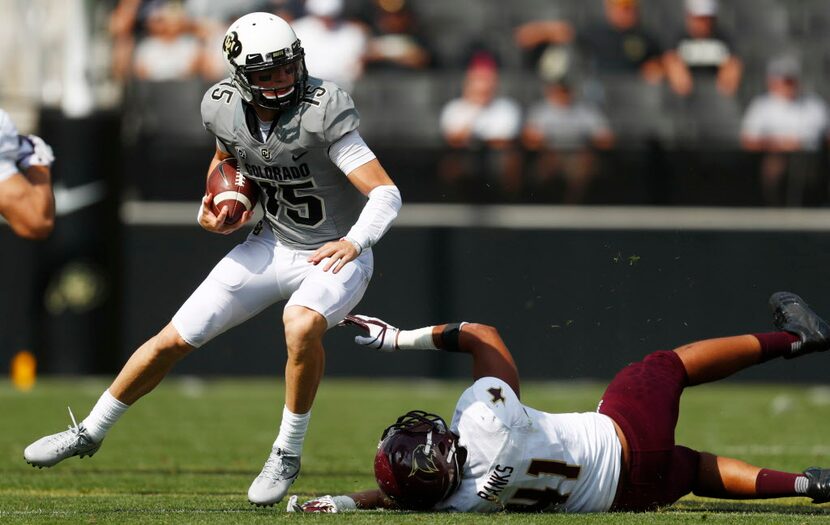 Colorado Buffaloes quarterback Sam Noyer (15) and Texas State Bobcats defensive end Jeff...