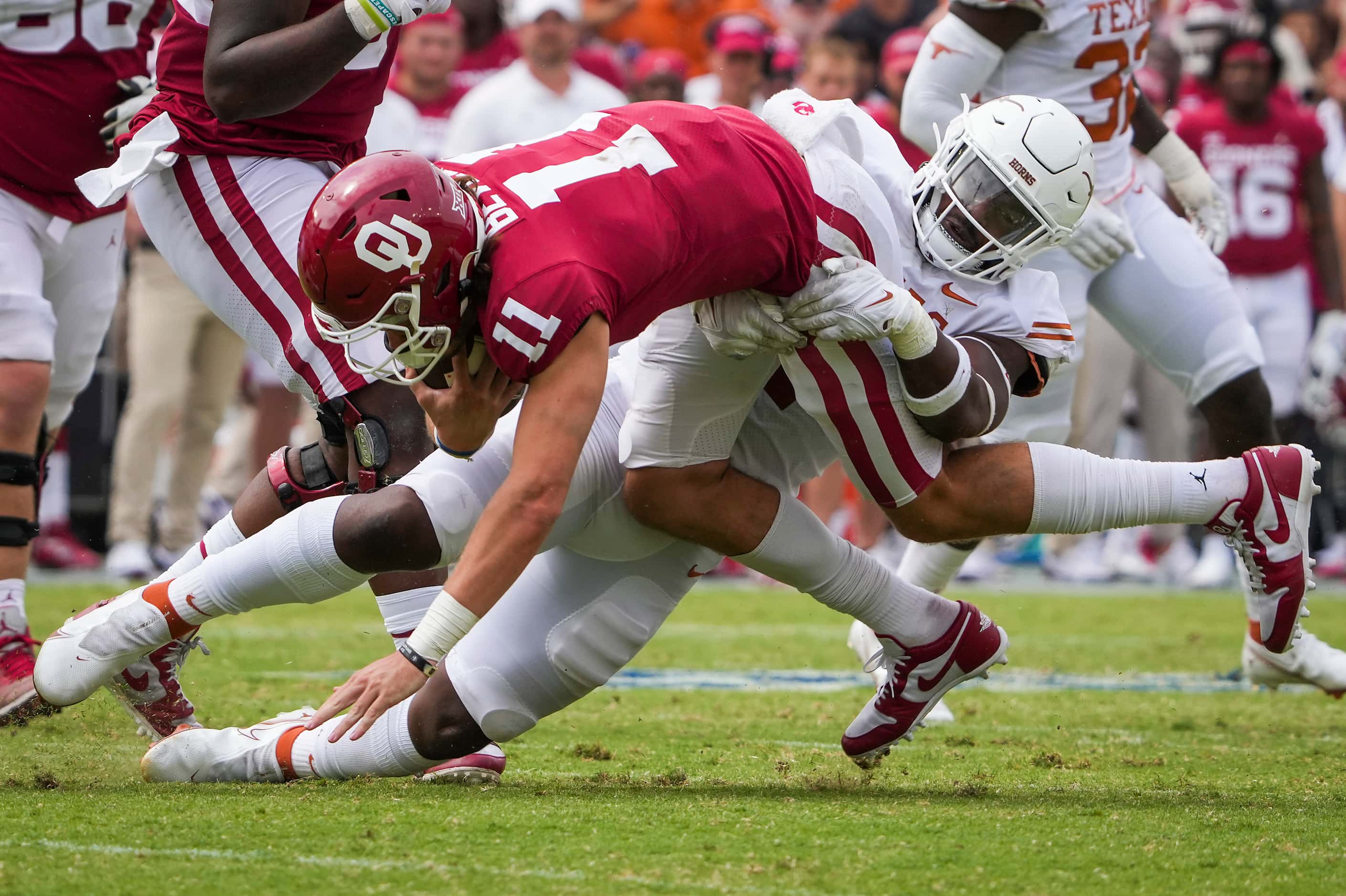 Oklahoma quarterback Davis Beville (11) is sacked by Texas defensive end Justice Finkley (1)...