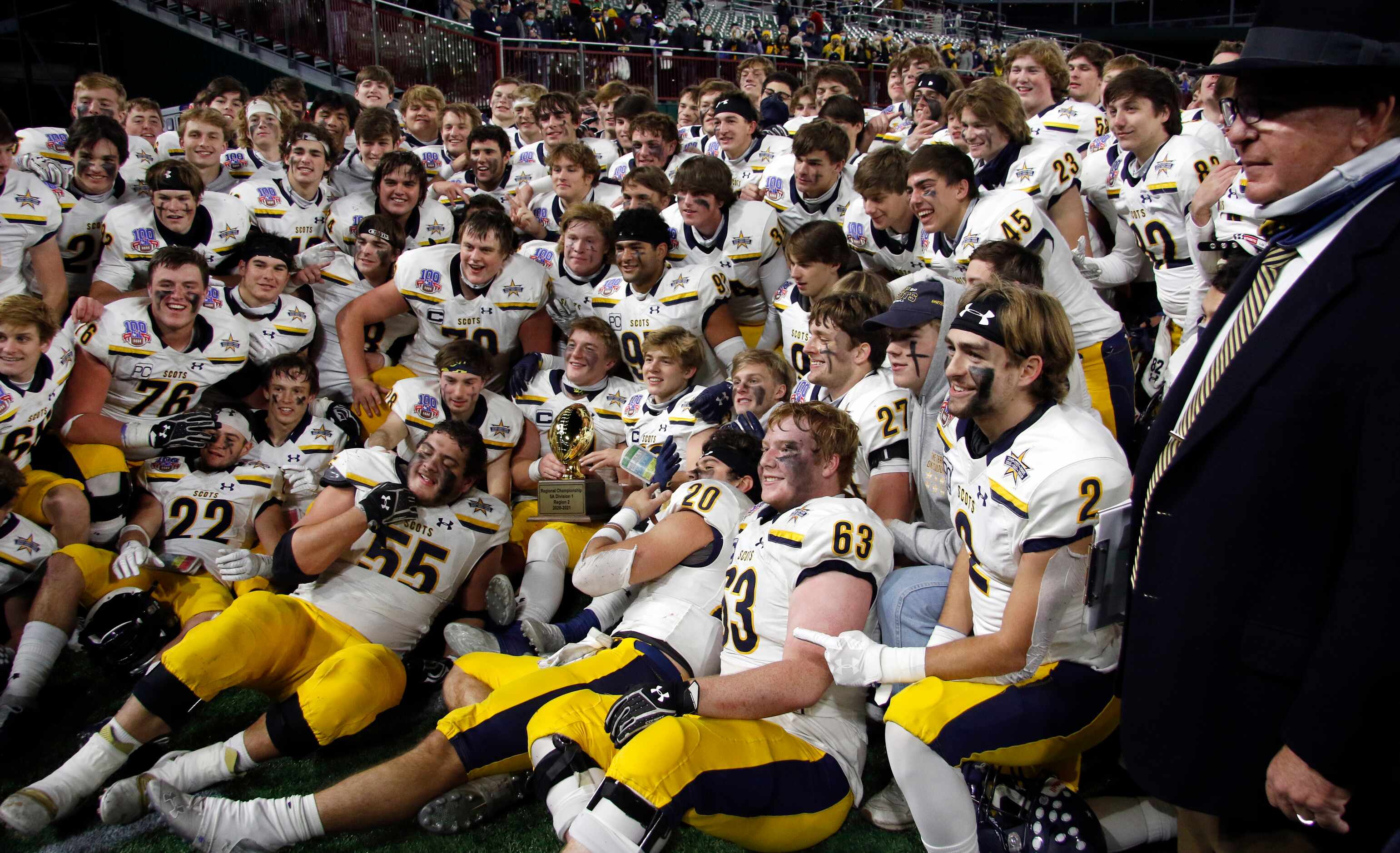 Highland Park Scots players and head coach Randy Allen pose for a photo with their 5A...