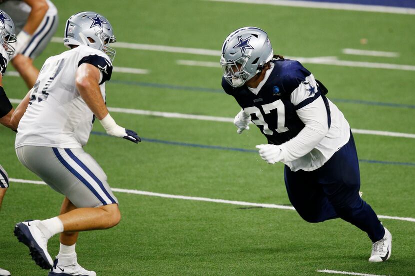 Dallas Cowboys defensive tackle Trysten Hill (97) attempts to pass Dallas Cowboys offensive...