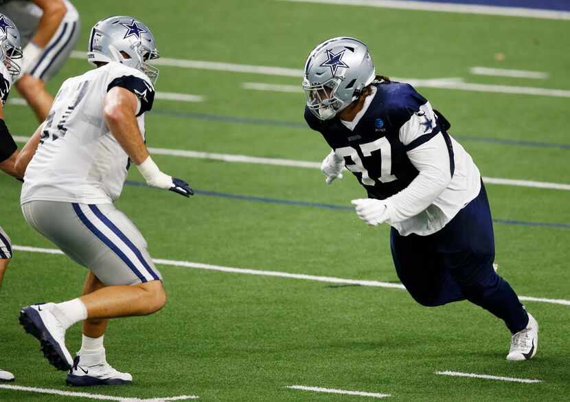 Dallas Cowboys defensive tackle Trysten Hill (97) attempts to pass Dallas Cowboys offensive...