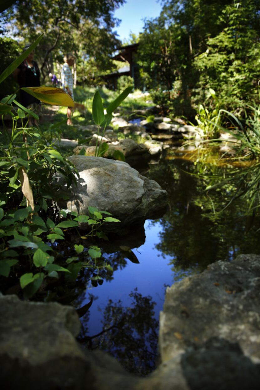 A narrow, recirculating stream around the courtyard collects rainwater and runs down a steep...