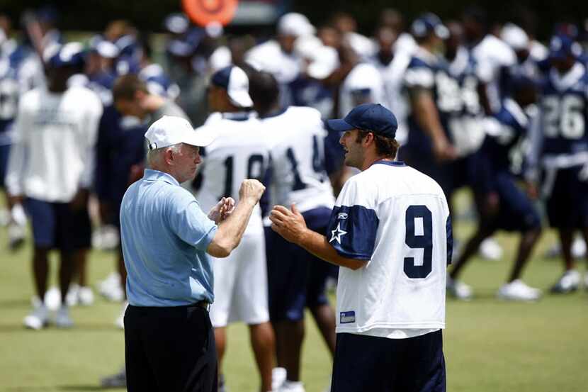 Dallas Cowboys quarterback Tony Romo (9) and owner Jerry Jones discuss throwing technique on...