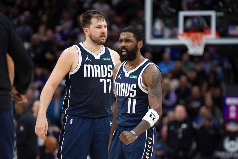 Dallas Mavericks guard Luka Doncic (77) and guard Kyrie Irving (11) react as the Sacramento...