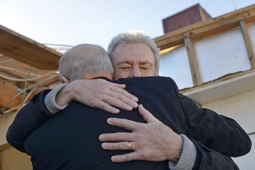 
Bill Sigsbee (facing camera) embraced Bishop Kevin Farrell in the backyard of Sigsbee’s...