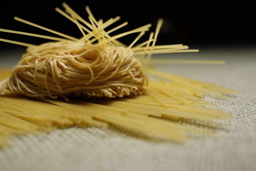 Canton dried noodle, center, and Capellini pasta noodle, top and bottom, for the ingredient...