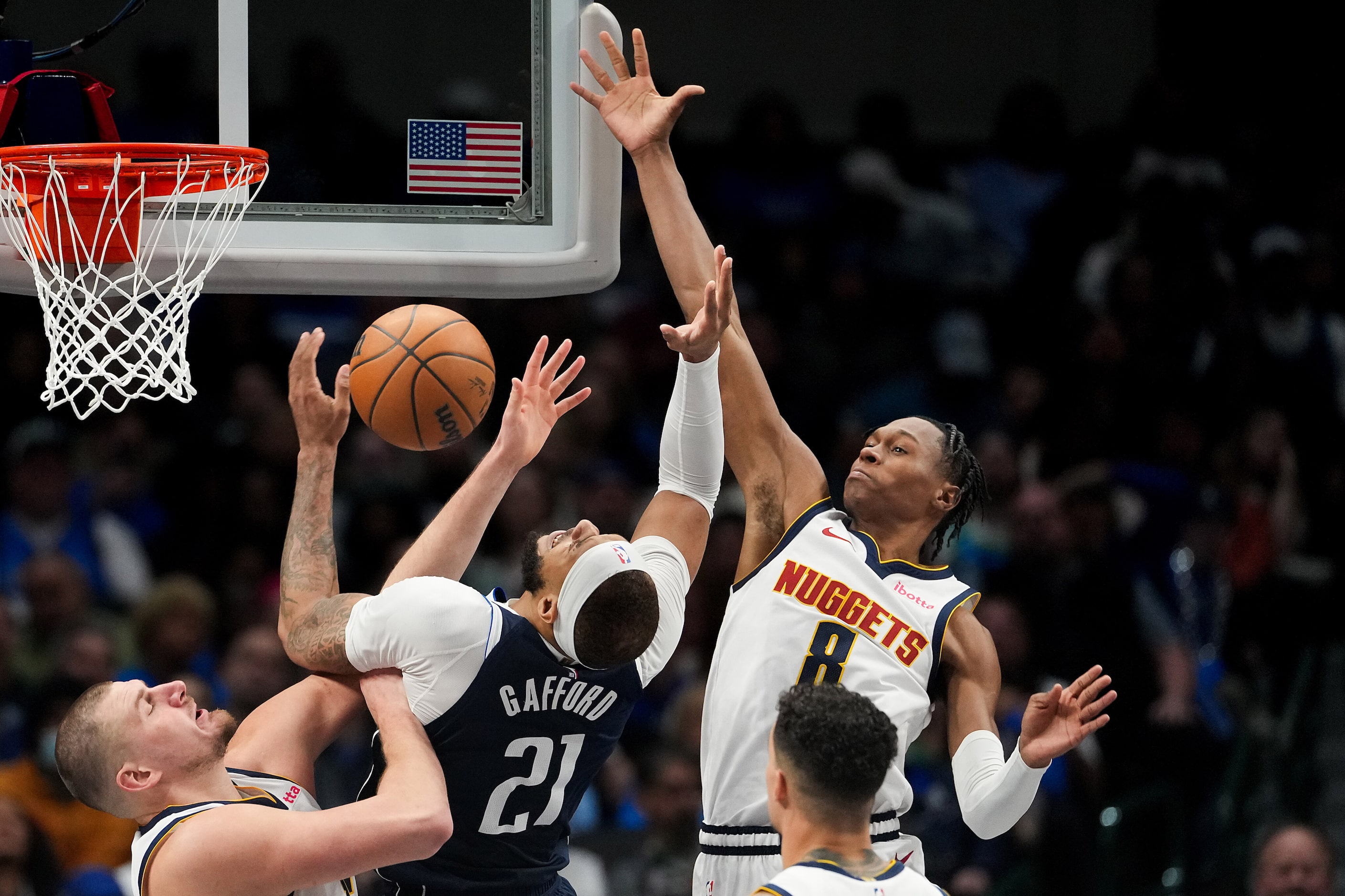 Dallas Mavericks center Daniel Gafford (21) is fouled by Denver Nuggets center Nikola Jokic...