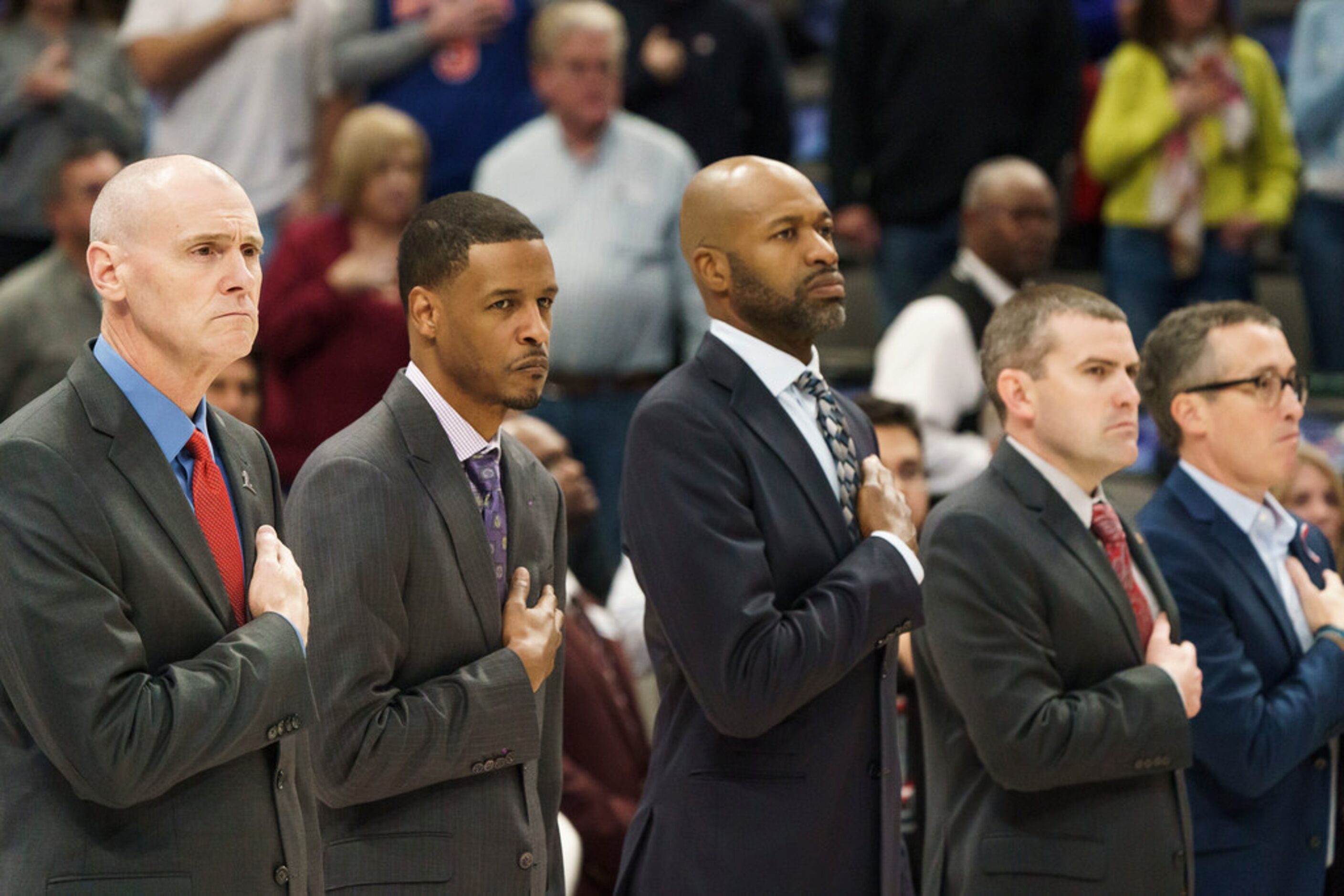 Dallas Mavericks coaches, including head coach Rick Carlisle (left) stand for the national...