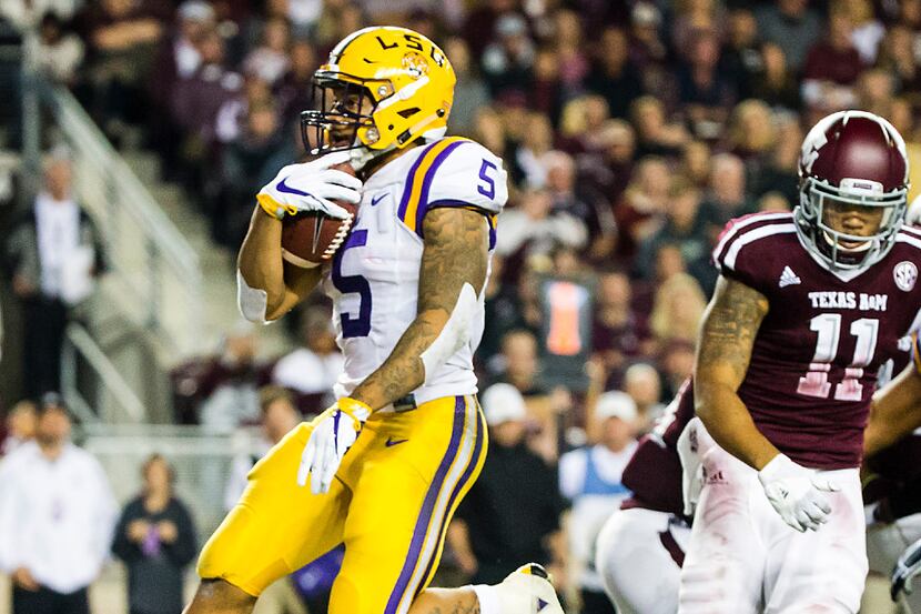 LSU running back Derrius Guice (5) scores on a 6-yard touchdown run past Texas A&M defensive...