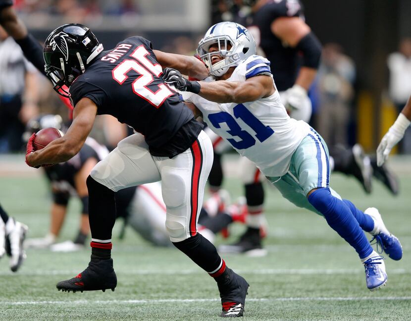 FILE - Cowboys cornerback Byron Jones (31) attempts to tackle Atlanta Falcons running back...