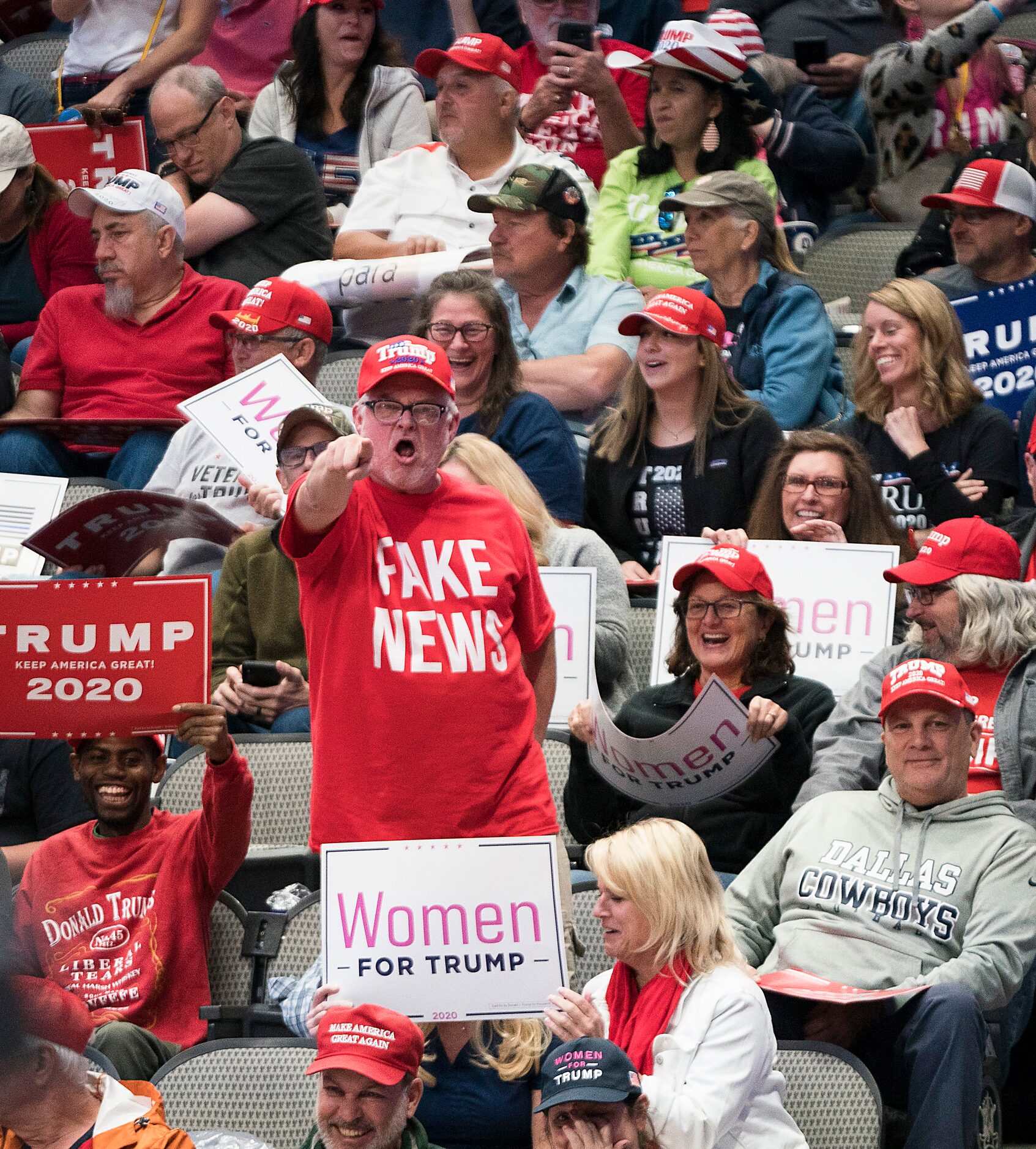 A supporter shouts “fake news” to toward the press pen before President Donald Trump arrived...