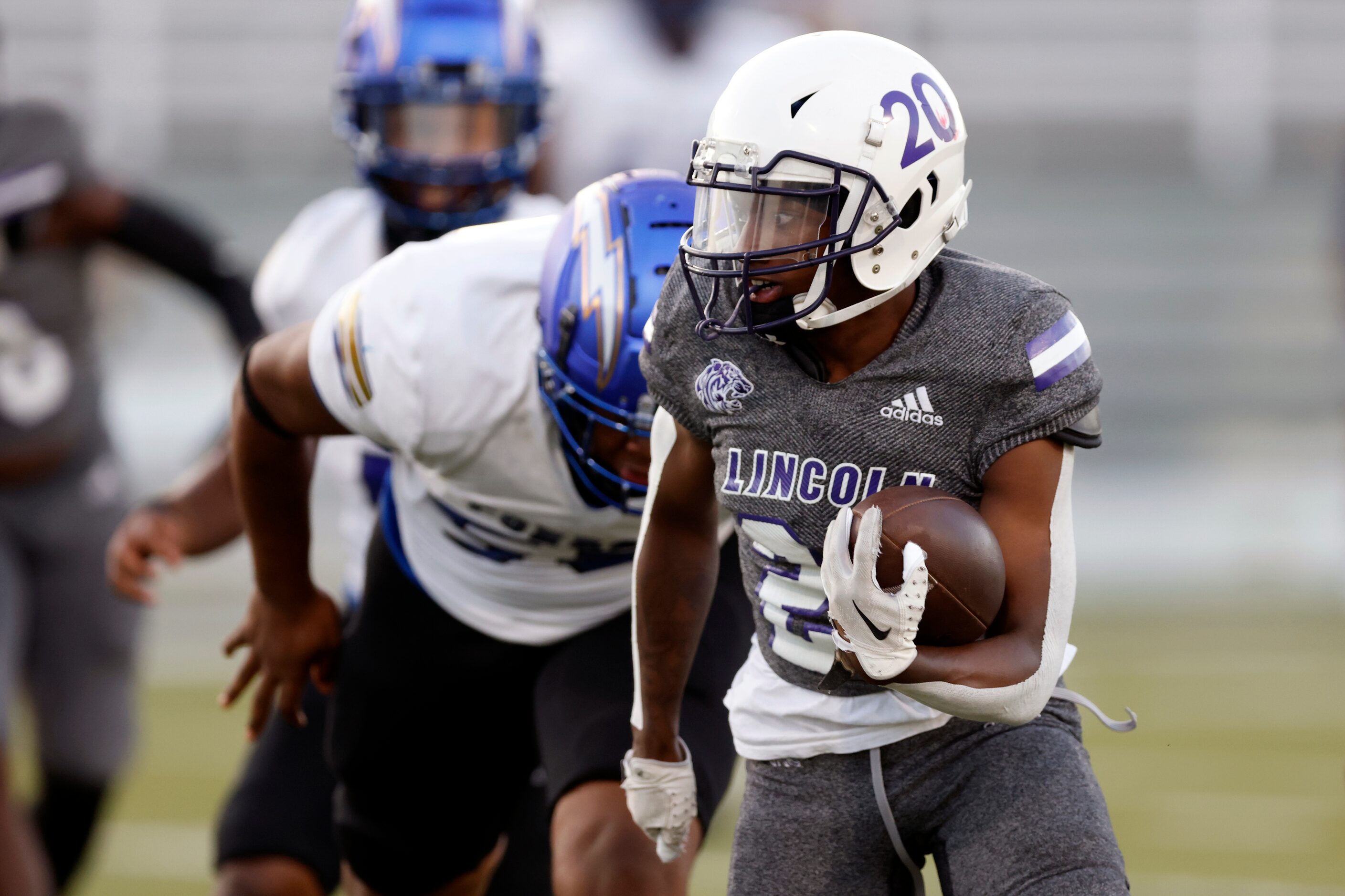 Lincoln running back Jaimirian Robertson (20) rushes the ball up the field during the first...