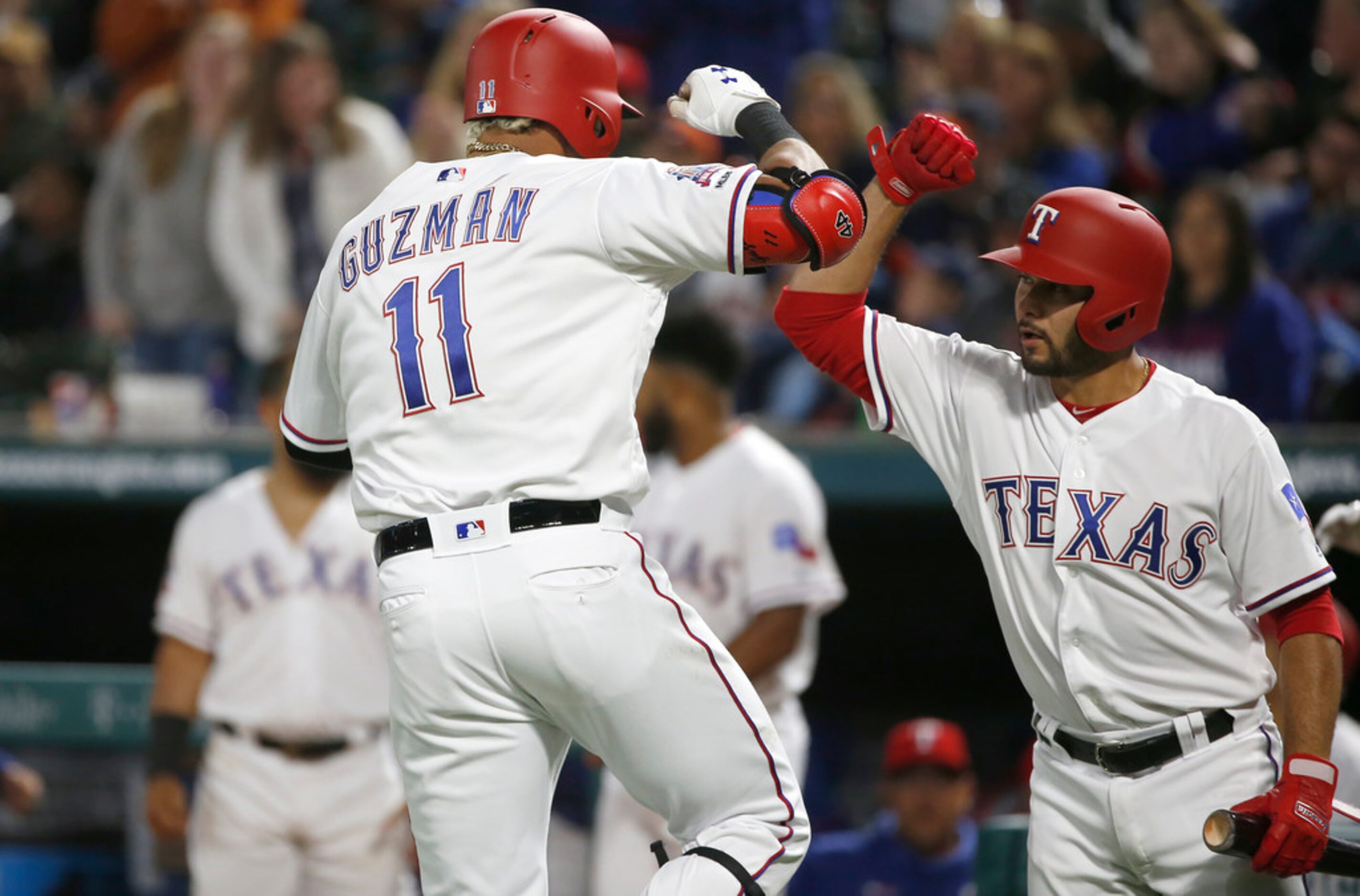 ARLINGTON, TX - APRIL 1: Ronald Guzman #11 and Isiah Kiner-Falefa #9 of the Texas Rangers...