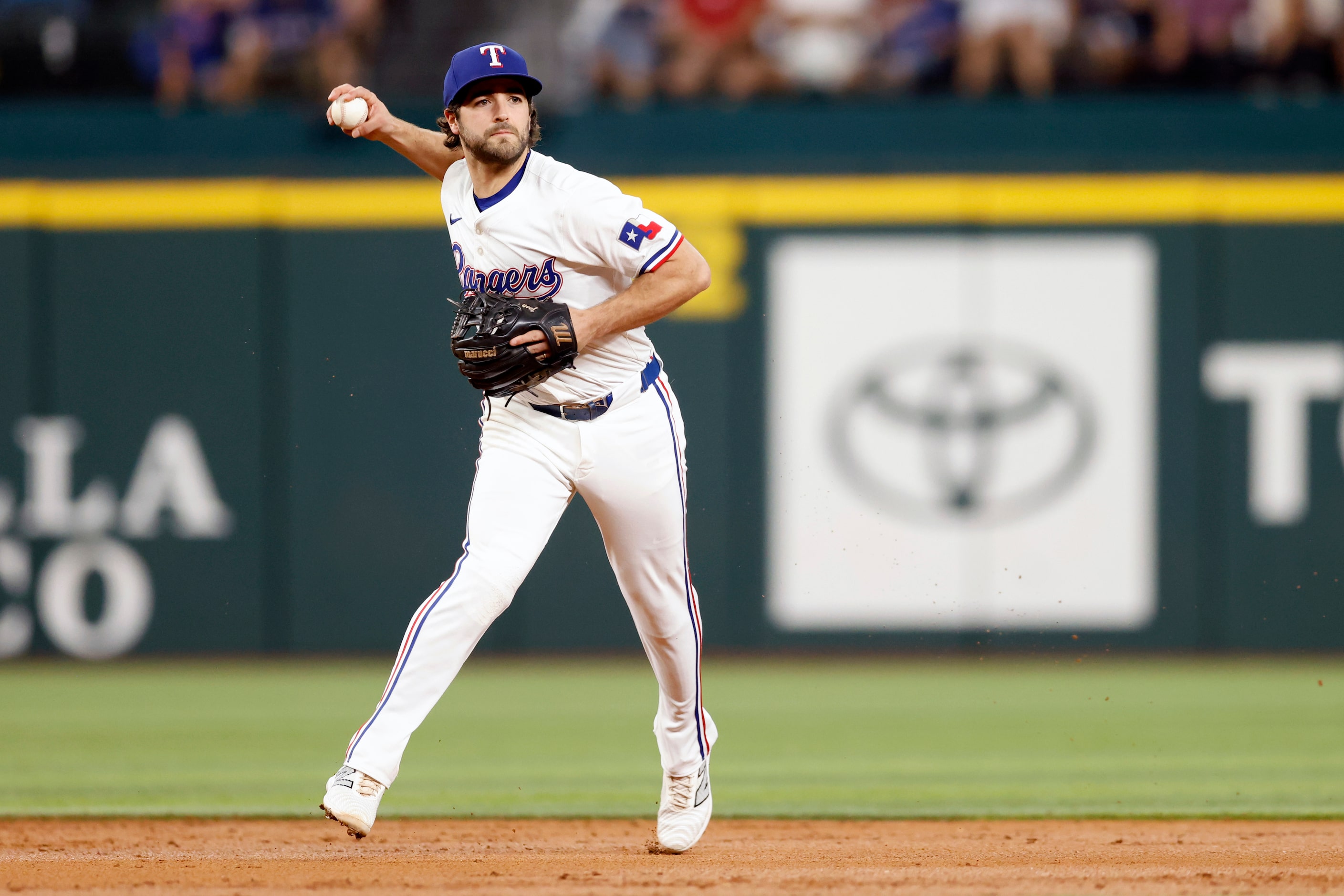 Texas Rangers shortstop Josh Smith (8) fields a ball and throws to first for an out during...