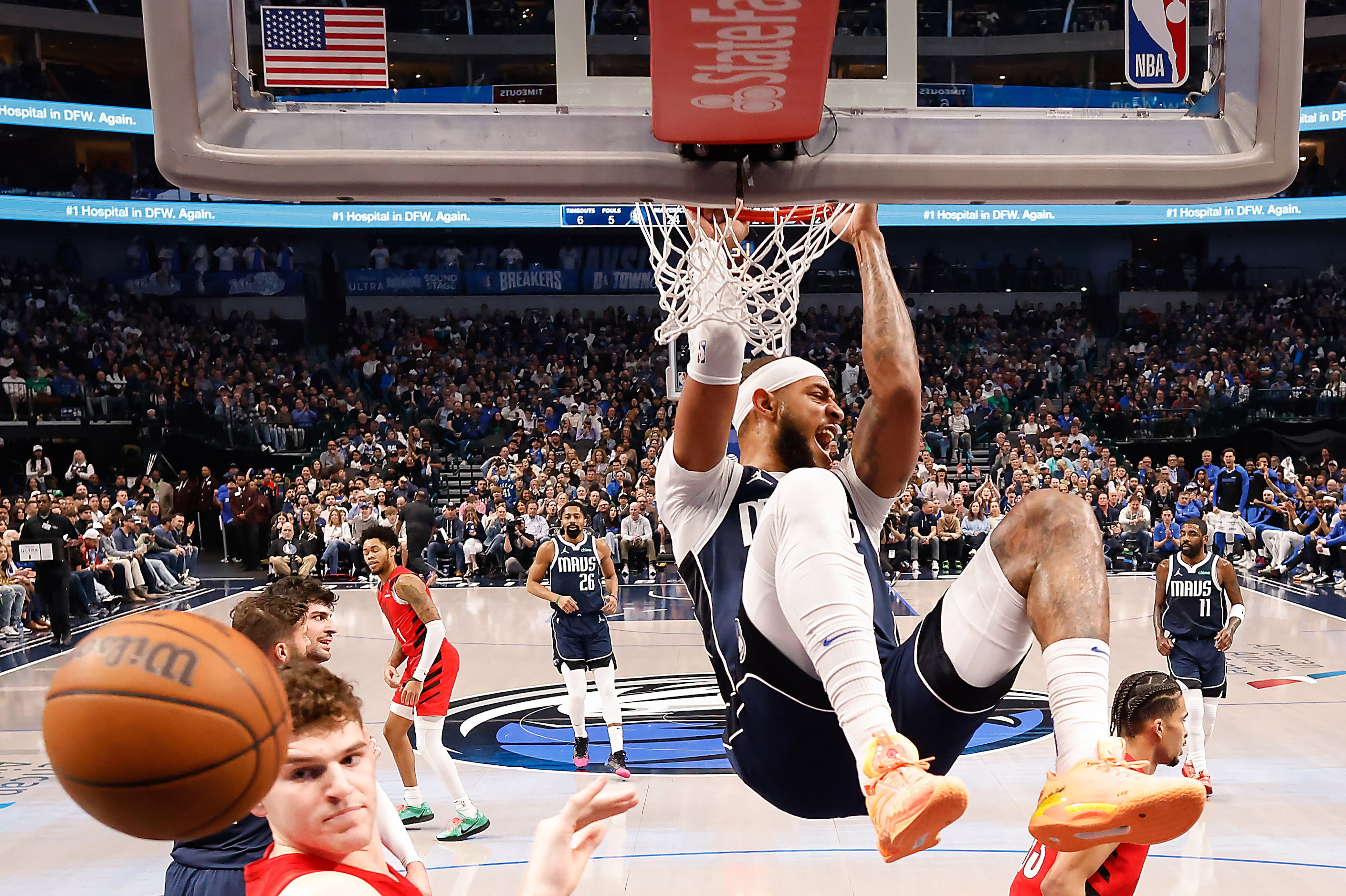 Dallas Mavericks center Daniel Gafford (21) dunks the ball past Portland Trail Blazers...