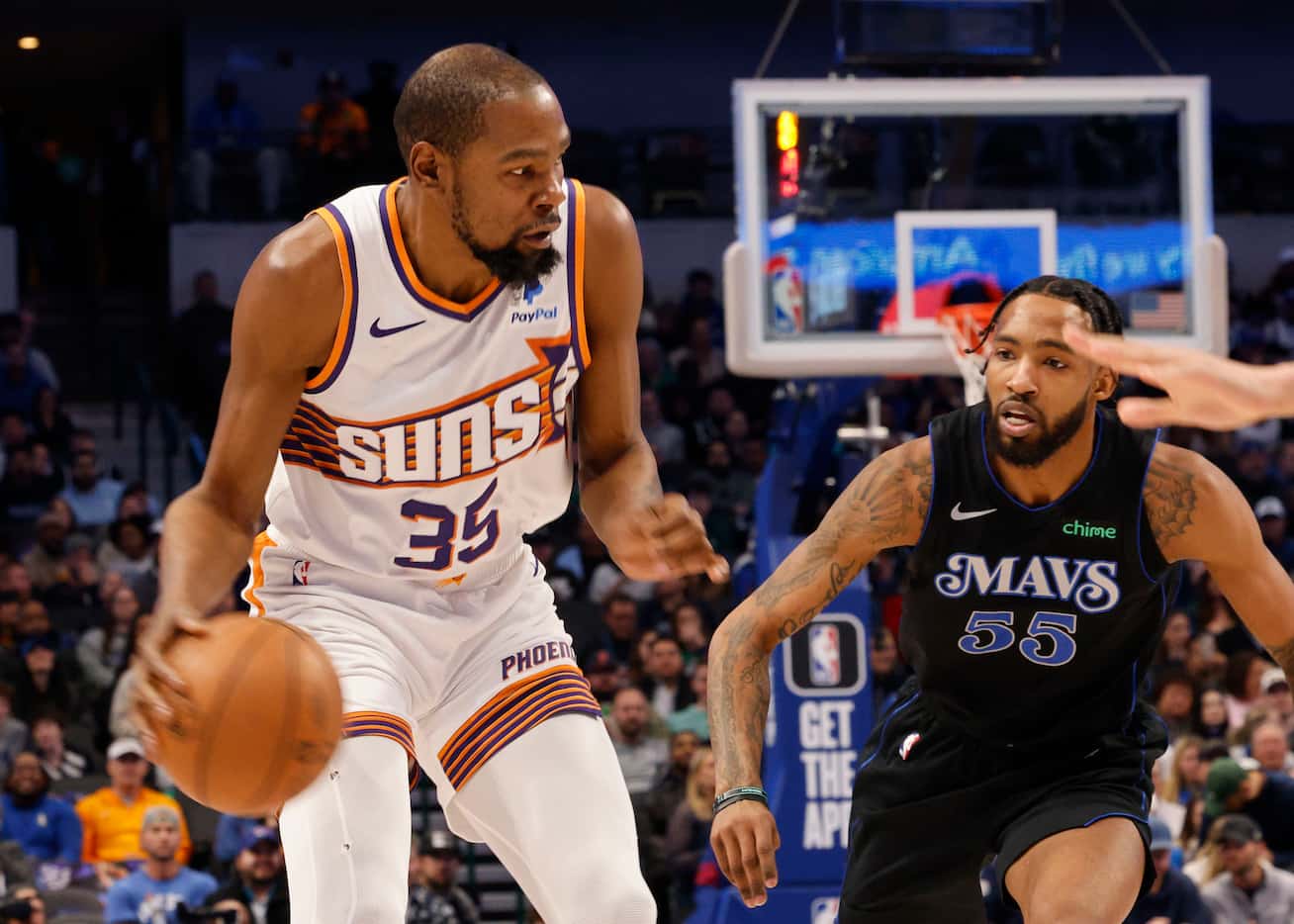 Phoenix Suns forward Kevin Durant (35) keeps the ball away from Dallas Mavericks forward...