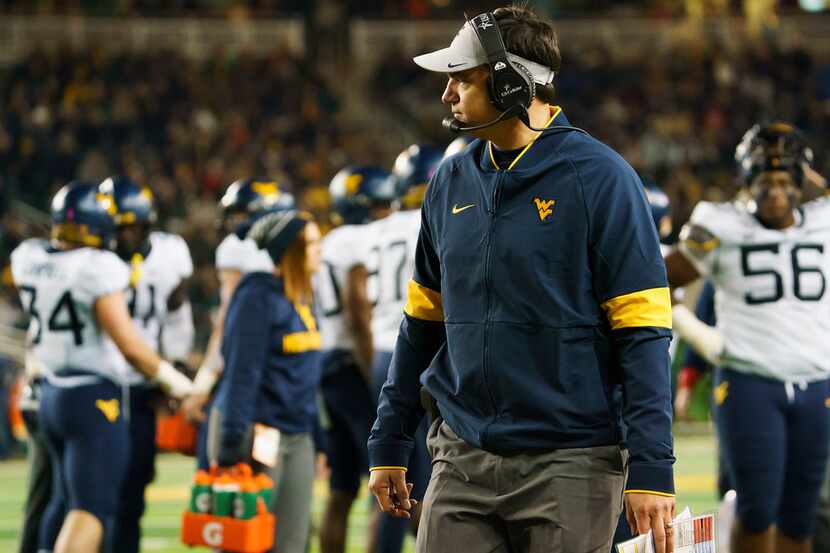 West Virginia head coach Neal Brown watches during a time out during the first half of an...