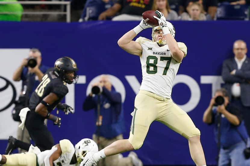 HOUSTON, TEXAS - DECEMBER 27: Christoph Henle #87 of the Baylor Bears catches a pass during...