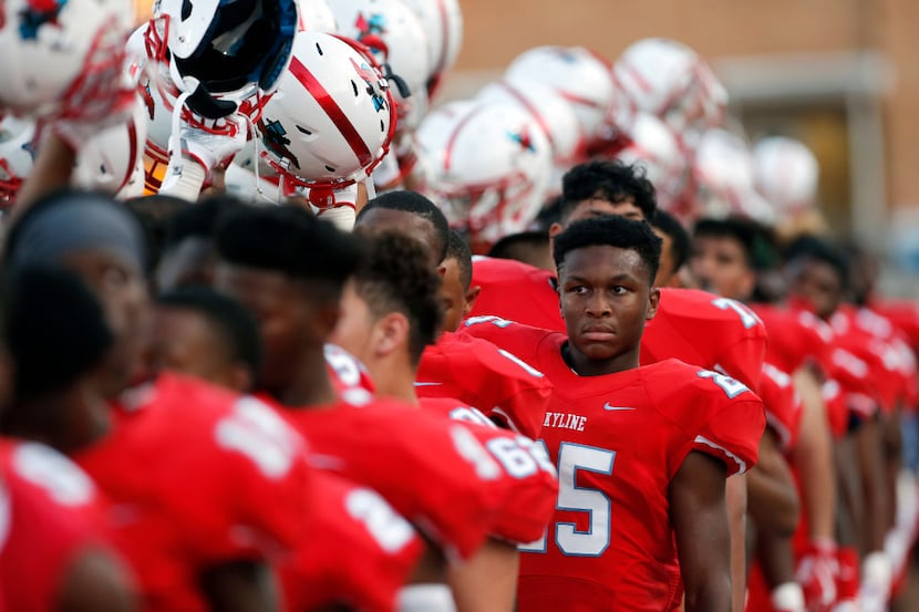 TXHSFB Skyline sophomore running back Javias Williams (25) and his teammates hold up their...
