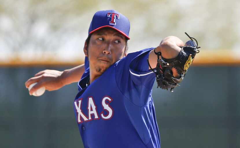 Texas Rangers pitcher Kyuji Fujikawa pitches in an intrasquad game prior to a spring...