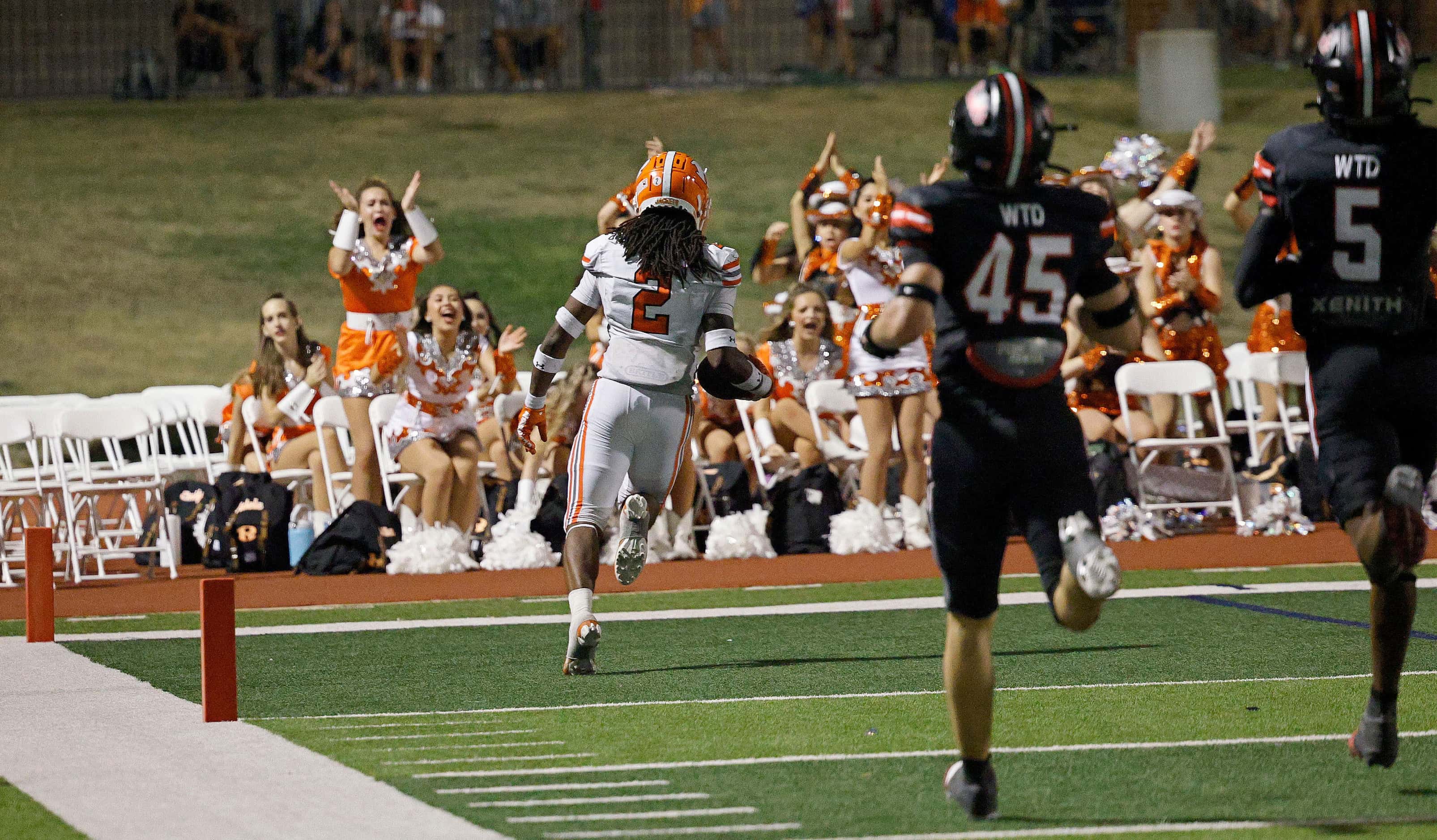 Rockwall's Ashten Emory (2) runs into the end zone for a touchdown as Rockwall-Heath's Chase...