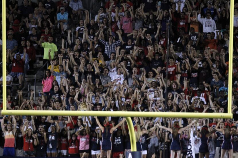 Allen fans celebrate after a touchdown against Hebron during their high school football game...