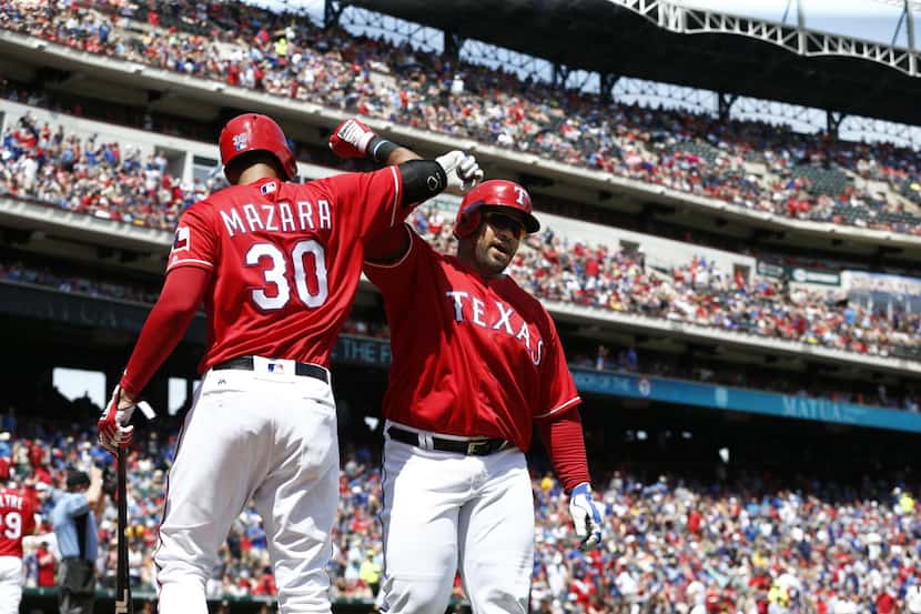 Texas Rangers right fielder Nomar Mazara (30) congratulates designated hitter Prince Fielder...