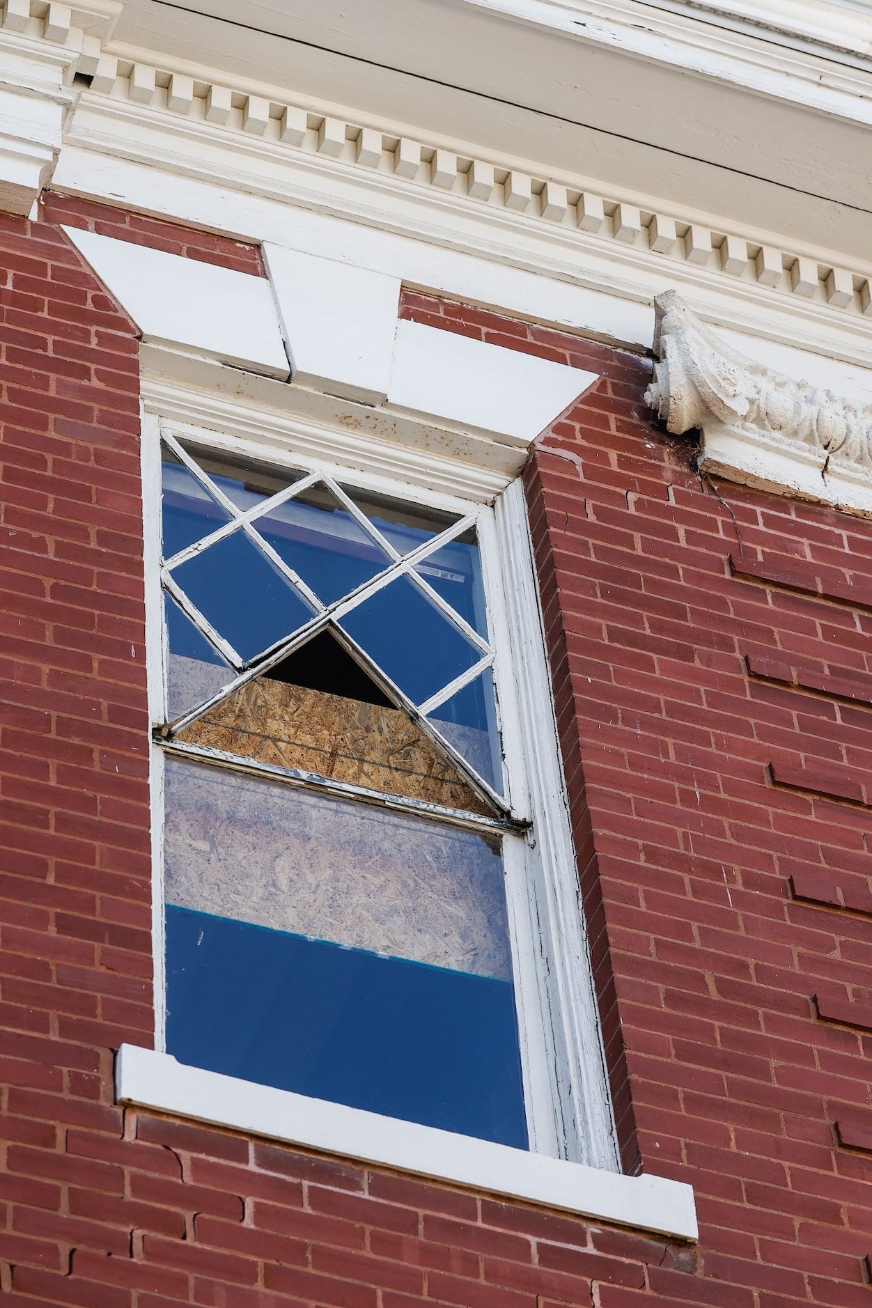 One of the broken windows in the old school building on the St. Joseph's Catholic Church site.