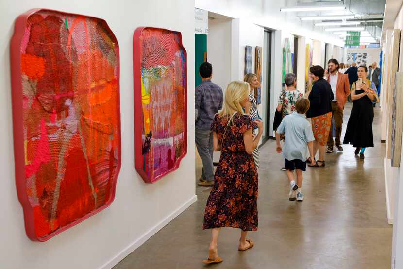 People browse artwork from different galleries at the Dallas Art Fair at the Fashion...