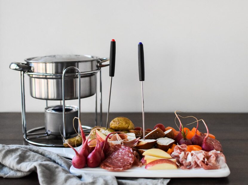 Herbed Cheese Fondue with fruit, potatoes and meats.