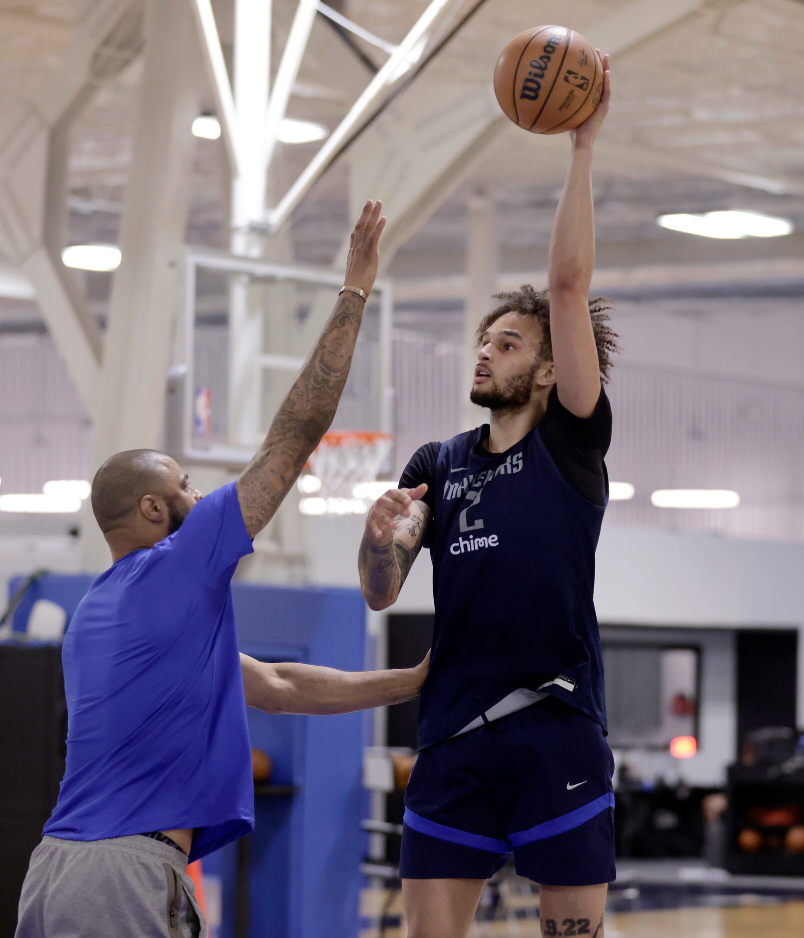 Former Dallas Maverick Tyson Chandler (left) puts pressure on center Dereck Lively II during...