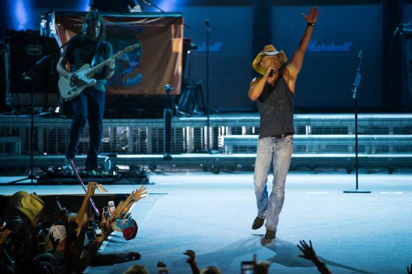 Kenny Chesney performs on stage during the his Spread the Love Tour concert at AT&T Stadium...