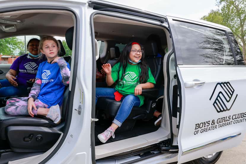 Bristol, 10 (left) and Alondra, 9, sit in a newly donated passenger van at the Boys & Girls...