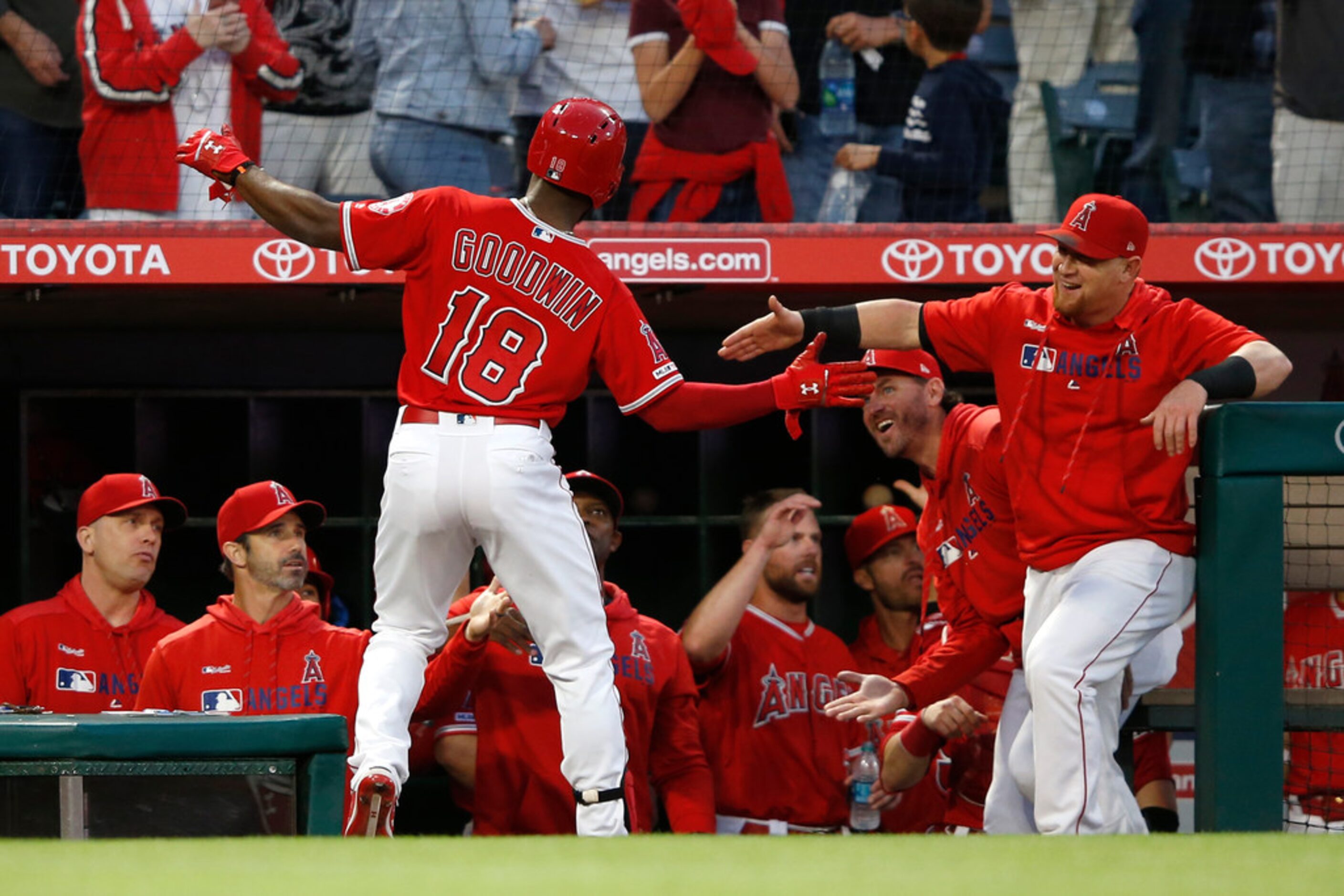 ANAHEIM, CALIFORNIA - MAY 24:  Cole Calhoun #56 congratulates Brian Goodwin #18 of the Los...