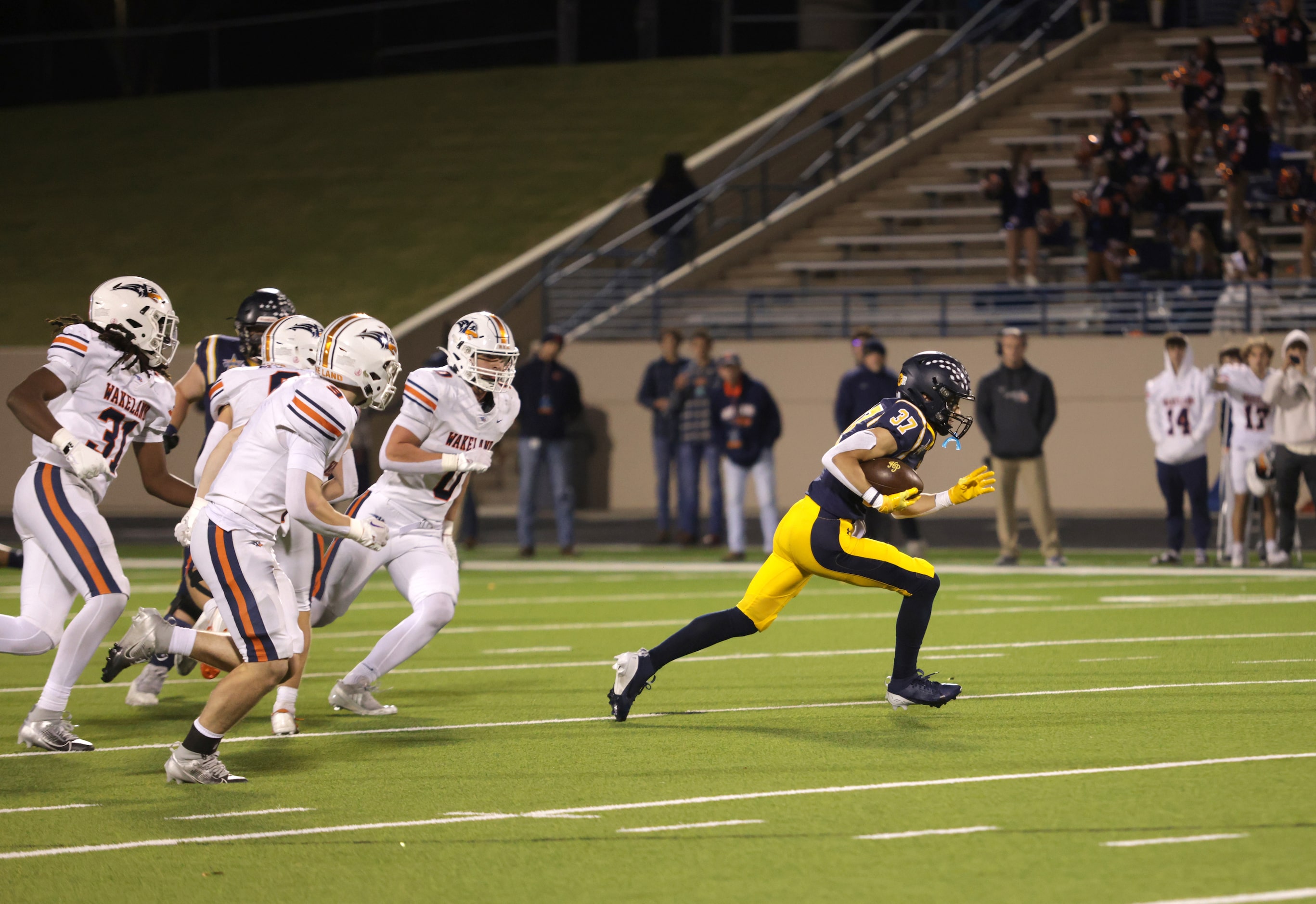 Highland Park High School player #37 Cannon Bozman breaks away from the pack in a football...