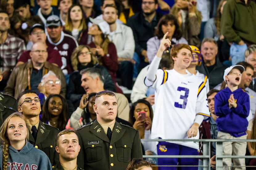 Texas A&M fans look on as LSU fans cheer a first down during the third quarter of an NCAA...