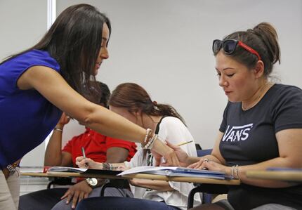 Student Wendy Birdsall, right, gets help from teacher Ana Melgarejo Acosta during Spanish...
