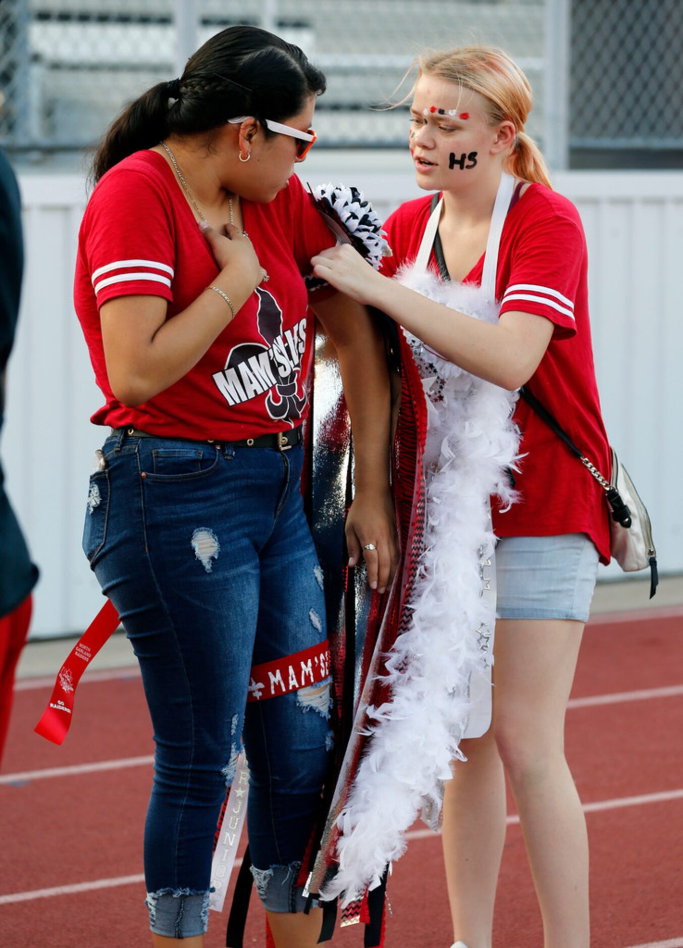 North Garland senior Melanie Vranovsky, right, adjusts the homecoming mum of friend Janie...