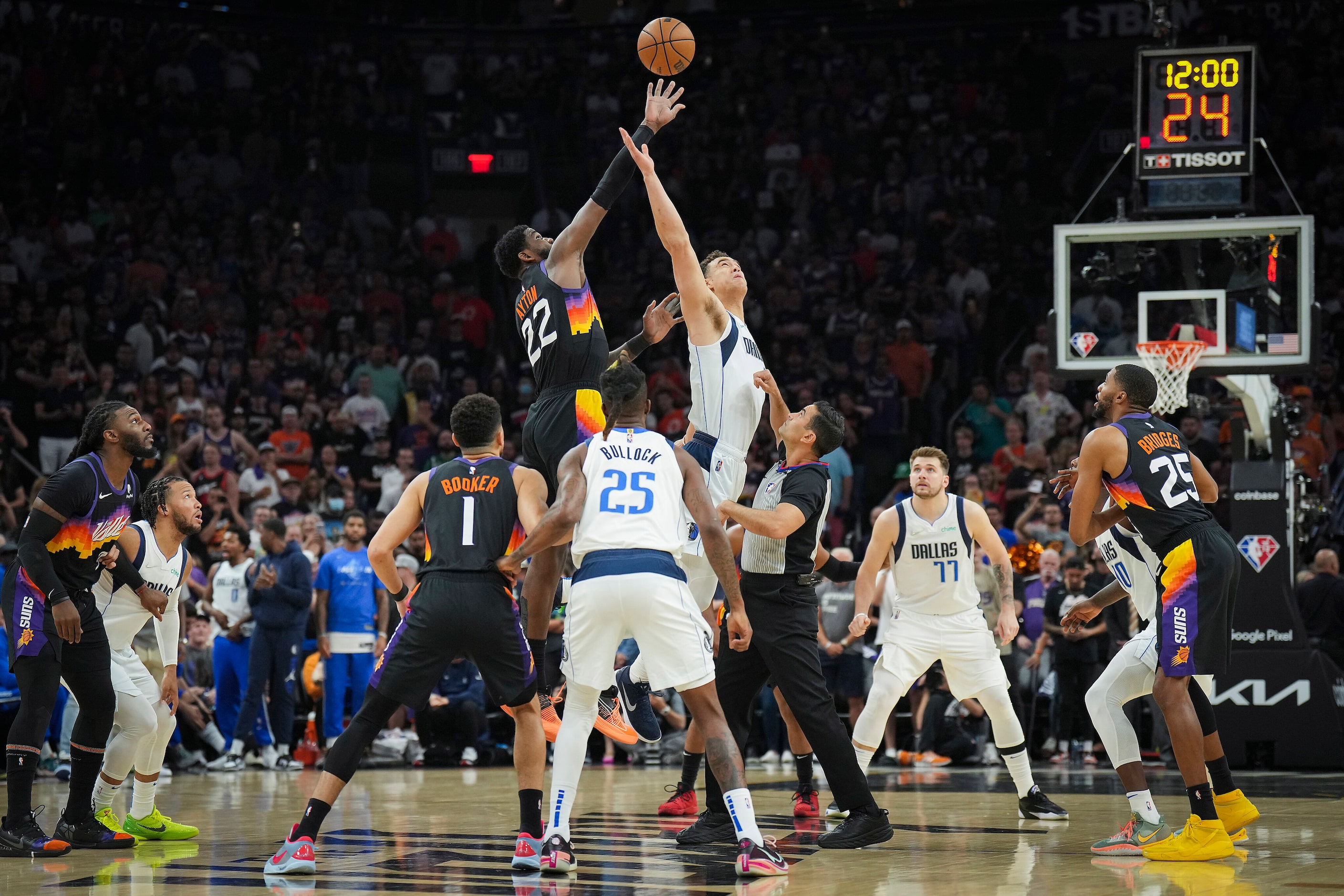 Dallas Mavericks center Dwight Powell (7) goes up for the opening tipoff against Phoenix...