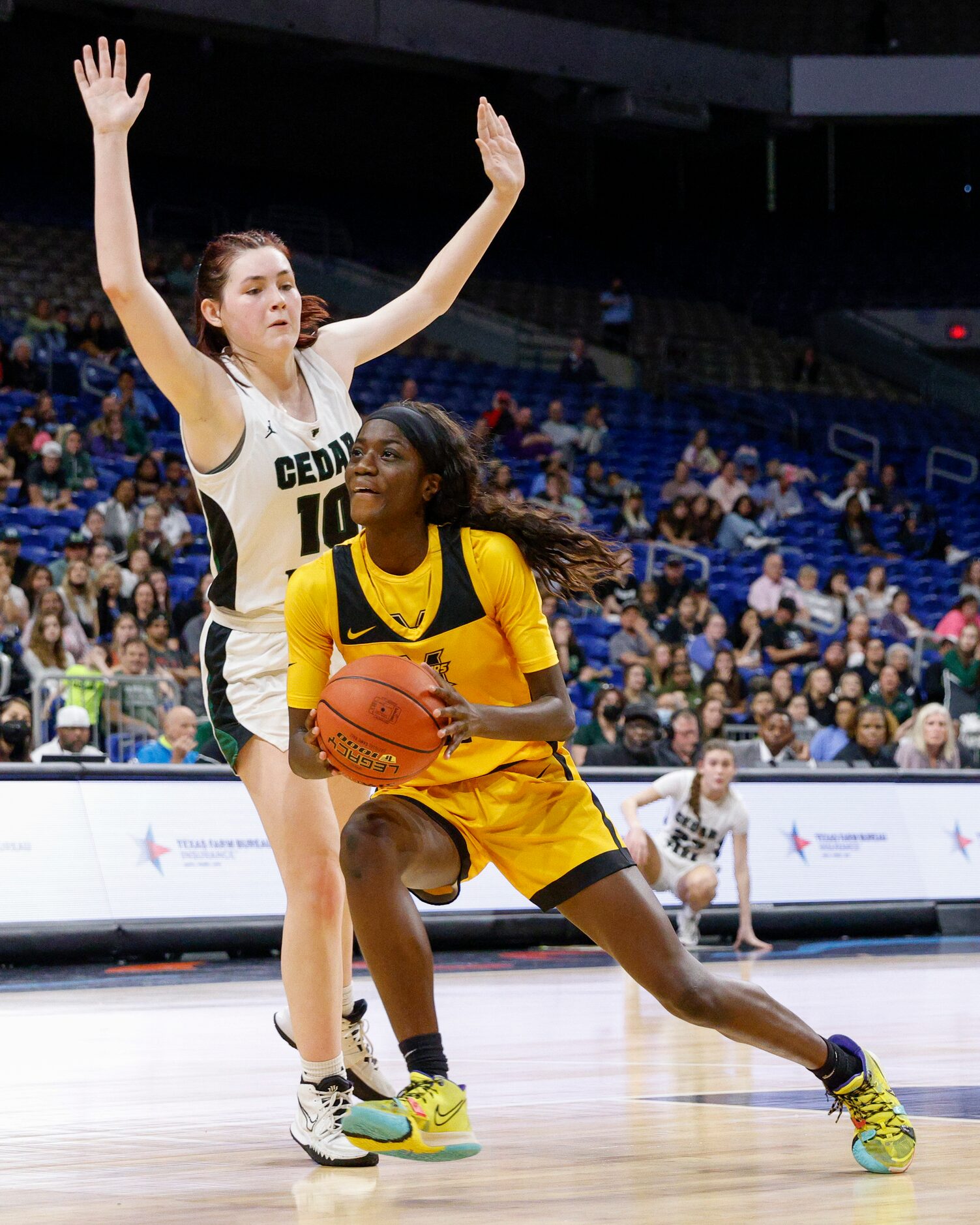 Frisco Memorial guard Falyn Lott (11) drives to the basket in front of Cedar Park forward...