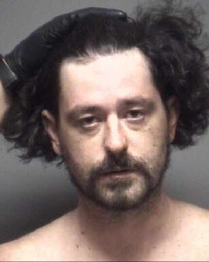 Robert Confalone had to be restrained for his mug shot when he was booked into the Grand...