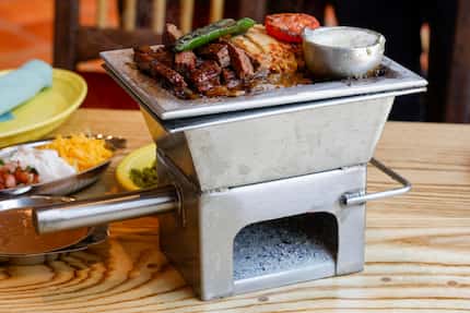 El Tiempo's steak and chicken fajitas are served from a small, hot oven called an anafre,...