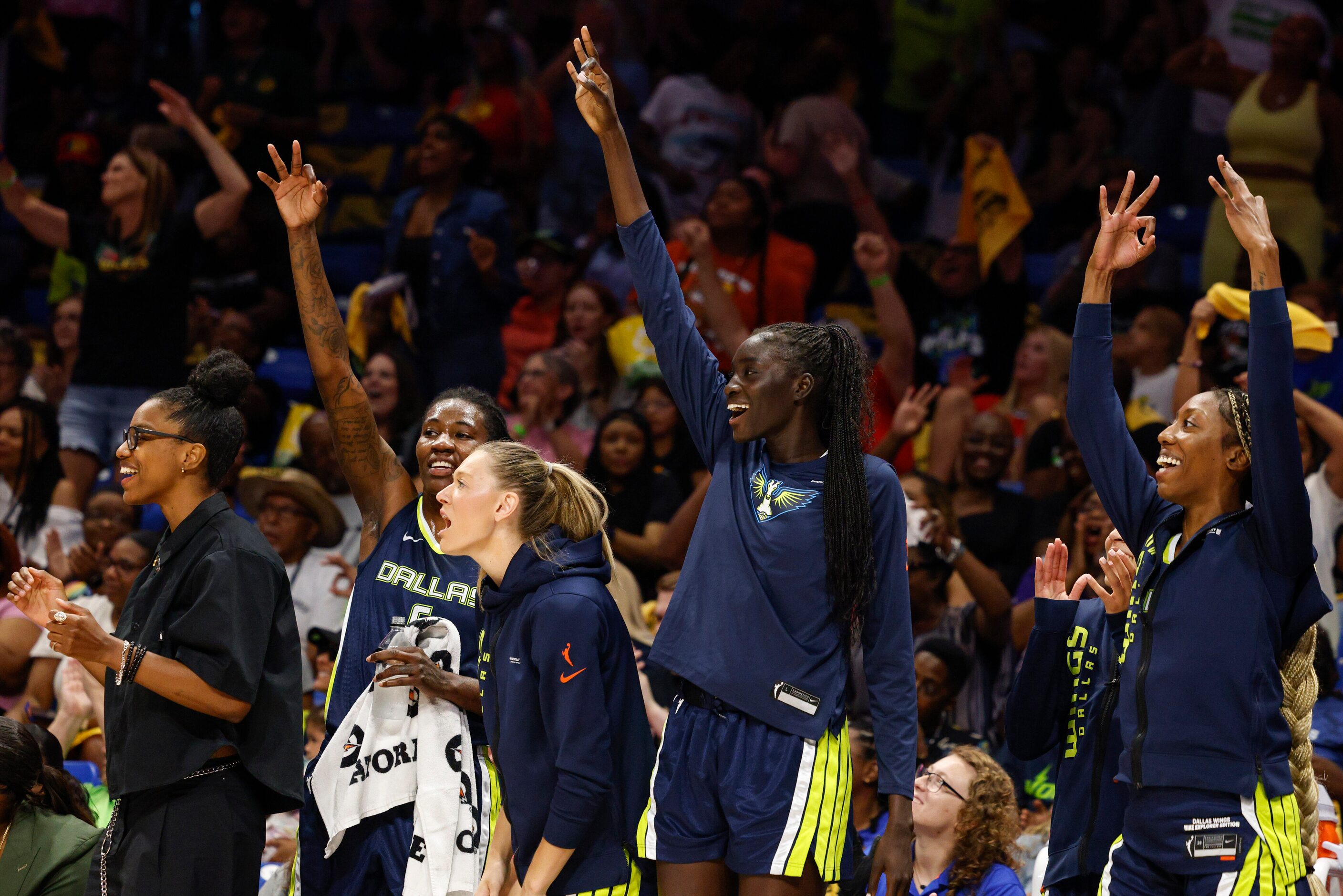 Dallas Wings players celebrate a three-point shot during the first half against the Phoenix...