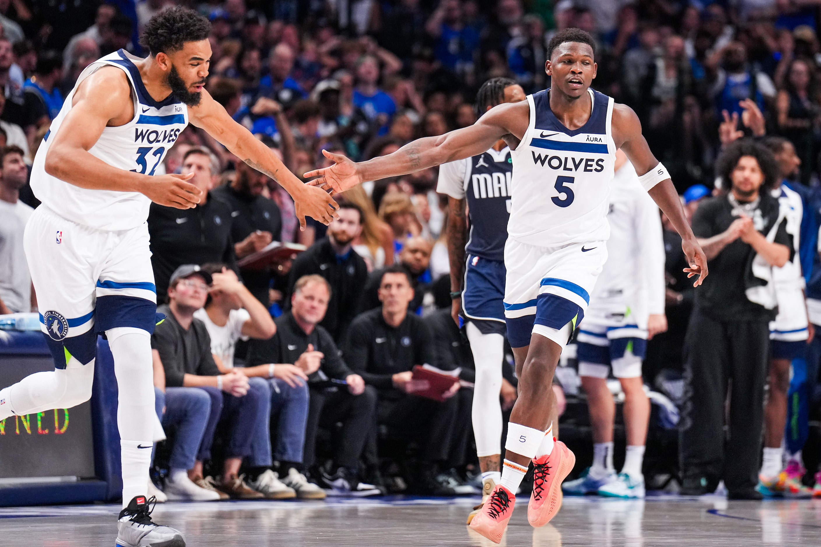 Minnesota Timberwolves guard Anthony Edwards (5) celebrates with center Karl-Anthony Towns...