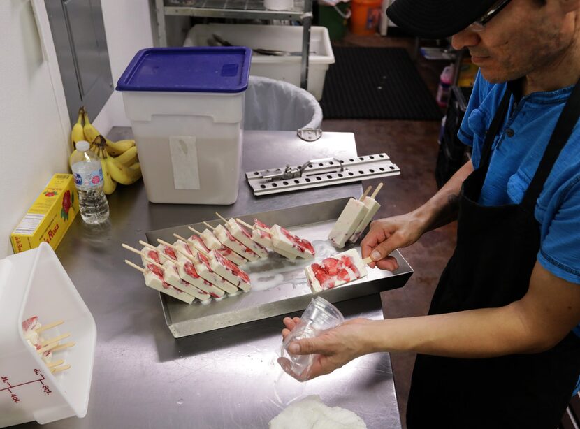 Jose Luis Ordóñez packages frozen treats at La Chula Michoacana in Dallas.